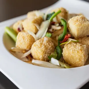 Salt and Pepper Tofu - Seasoned, crispy, fried tofu quick sautéed with fresh jalapenos, pepper, and five spice