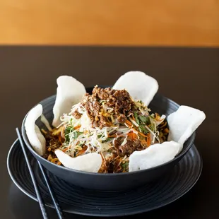 Tamarind Beef Salad - Sautéed beef in tamarind sauce with onions, pickled cabbage, carrots, fresh herbs, fried shallots, crushed peanuts