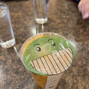 a plastic cup with a smiley face on it