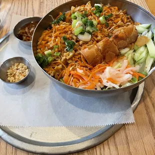 a bowl of noodles with meat and vegetables