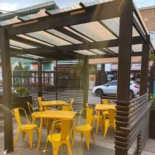 a restaurant with yellow chairs and tables