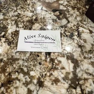 a sign on a marble table