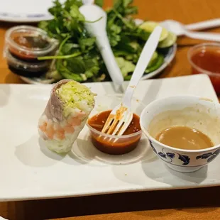a plate of food with dipping sauces