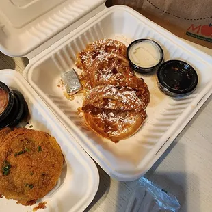 a breakfast of waffles and a sandwich