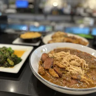 Jambalaya topped with crab over rice w/ side of Lemon Herb Grilled Broccolini