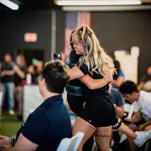 Celebrating her athlete at a competition