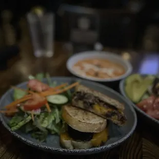 Short rib grilled cheese sandwich with side salad and tomato soup