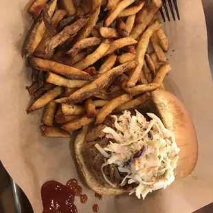 Barbecue sandwich with slaw and a side of fries