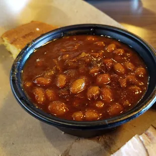 The baked beans here are delicious! Very smoky flavored and sweet.