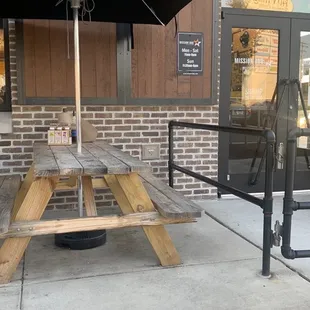 a picnic table with an umbrella