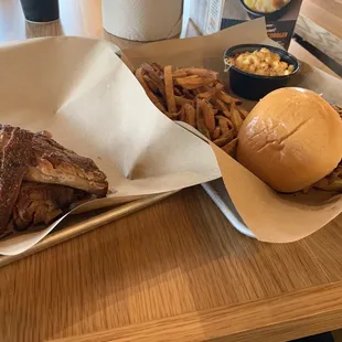 a plate of ribs, french fries, and a burger