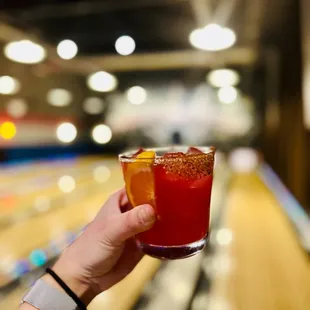 a person holding up a drink