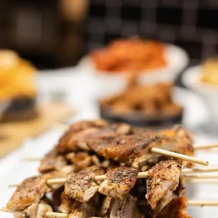 chicken skewers on a white plate