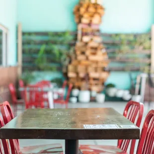 a wooden table and red chairs