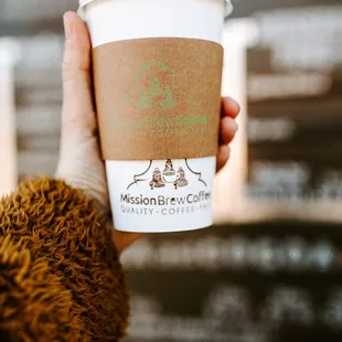 a person holding a cup of coffee