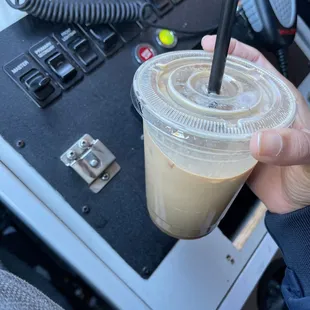 a hand holding a cup of coffee