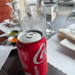 a can of coke on a table