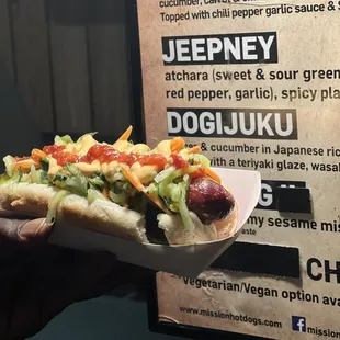 a person holding a hot dog