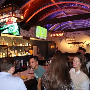 a group of people sitting at a bar