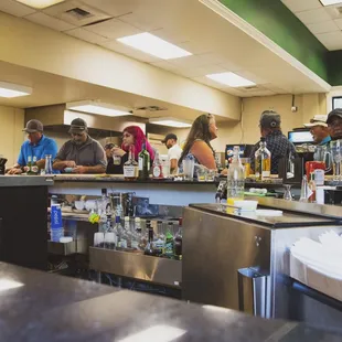 a group of people sitting at the bar