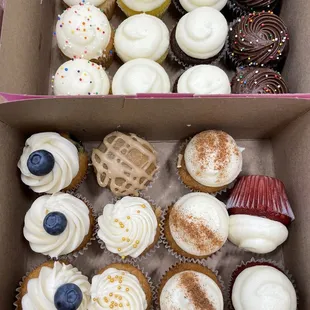 a variety of cupcakes in a box