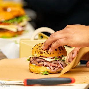 a person putting a sandwich in a bag
