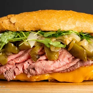a roast beef sandwich on a cutting board