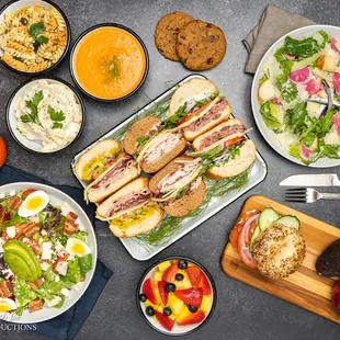 a spread of sandwiches and salads
