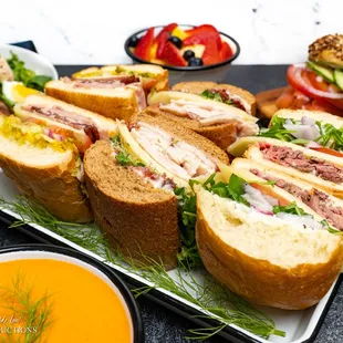 a platter of sandwiches and dips
