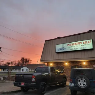 two trucks parked in front of a restaurant