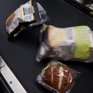 a bag of bread and a sandwich on a conveyor belt