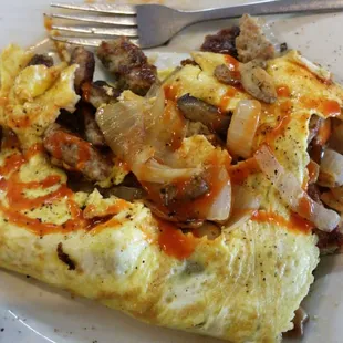 Omelet with sausage, peppers, and onions.