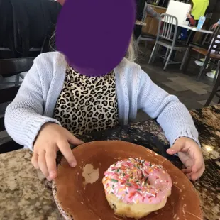 The oldest grand excited to try her donut