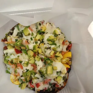a pizza in a styrofoam container