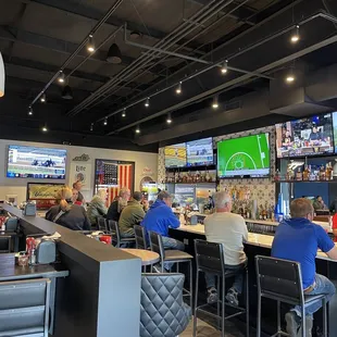 Bar area with lots of TV&apos;s completely full at 2:00pm on a Thursday