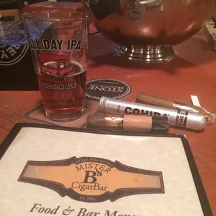 a glass of beer and a menu