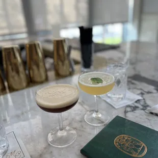 two cocktails on a marble table
