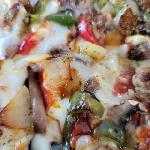 Deluxe Pizza with pepperoni, sausage, mushrooms, onions and bell peppers.