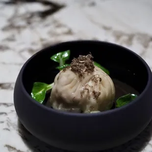 Chicken, shrimp, and pig trotter dumpling with preserved yuzu and black truffle