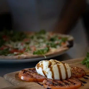 two pizzas with mozzarella and tomatoes