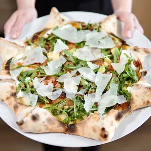 Star Carlos-pizza filled with ricotta cheese, mozzarella, chorizo sausage, tomatoes, arugula, avocado, Italian parmesan and jalapeño sauce