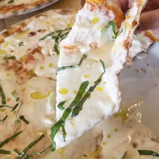 Claudio - Italian tomato sauce, mozzarella, fresh burrata stracciatella cheese, truffle oil and basil. Vegetarian.