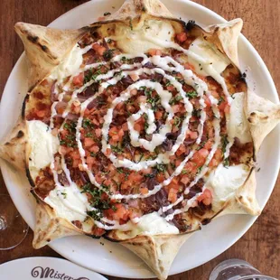 Star Beckham: Star shaped pizza, filled with ricotta cheese, mozzarella, bacon, onions, fresh tomatoes, ranch dressing and basil