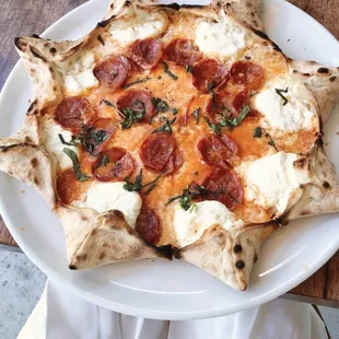 Star Luca - Star shaped pizza filled with ricotta cheese, spicy salami, mozzarella, Italian tomato sauce and basil