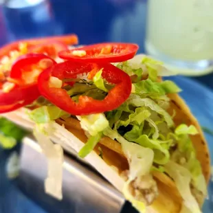 a taco with lettuce and tomatoes