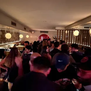 a crowd of people at a bar