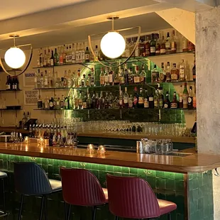 a bar with red and blue chairs