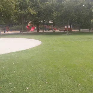 Surrounded by full trees, large grassy area for free okay and a basketball court