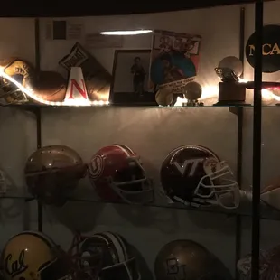 football helmets on display in a glass case