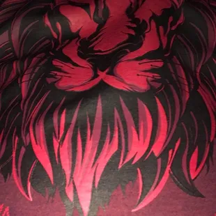 a lion&apos;s head on a red shirt